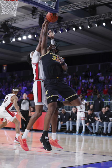 In a photo provided by Bahamas Visual Services, Texas Tech's Warren Washington defends against Michigan's Tarris Reed Jr. during the first half of an NCAA college basketball game in the Battle 4 Atlantis at Paradise Island, Bahamas, Friday, Nov. 24, 2023. (Tim Aylen/Bahamas Visual Services via AP)