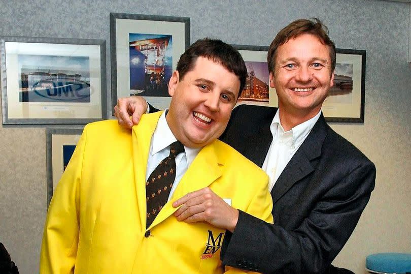 Peter Kay wearing an M.E.N Arena jacket