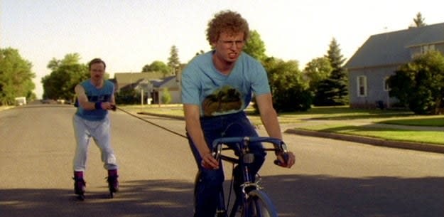 A teenager rides his bike and pulls a man on rollerblades in "Napoleon Dynamite"