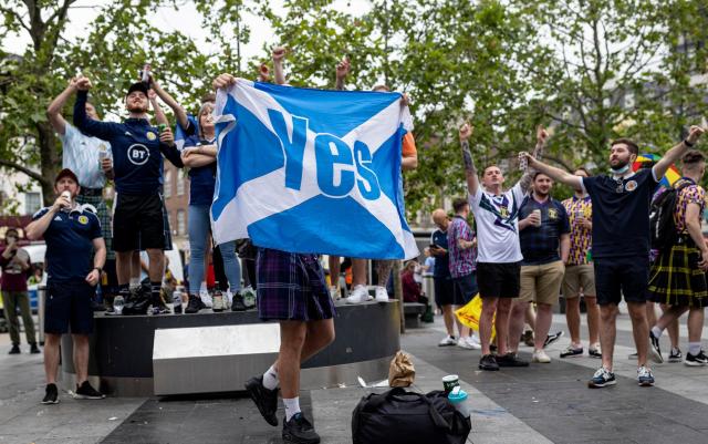 A Scotland fan holds up the flag of Scotland with the word &quot;Yes&quot; written across it, associated with the campaign for Scotland&#39;s independence from the United Kingdom - Rob Pinney/Getty Images Europe