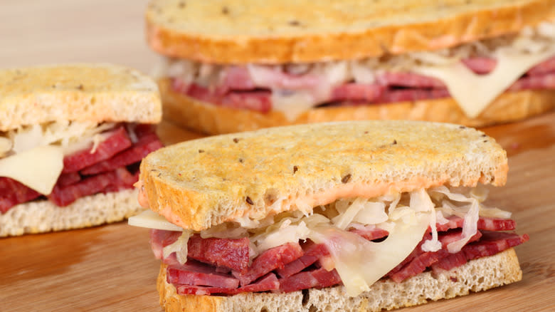 three toasted Reuben sandwiches