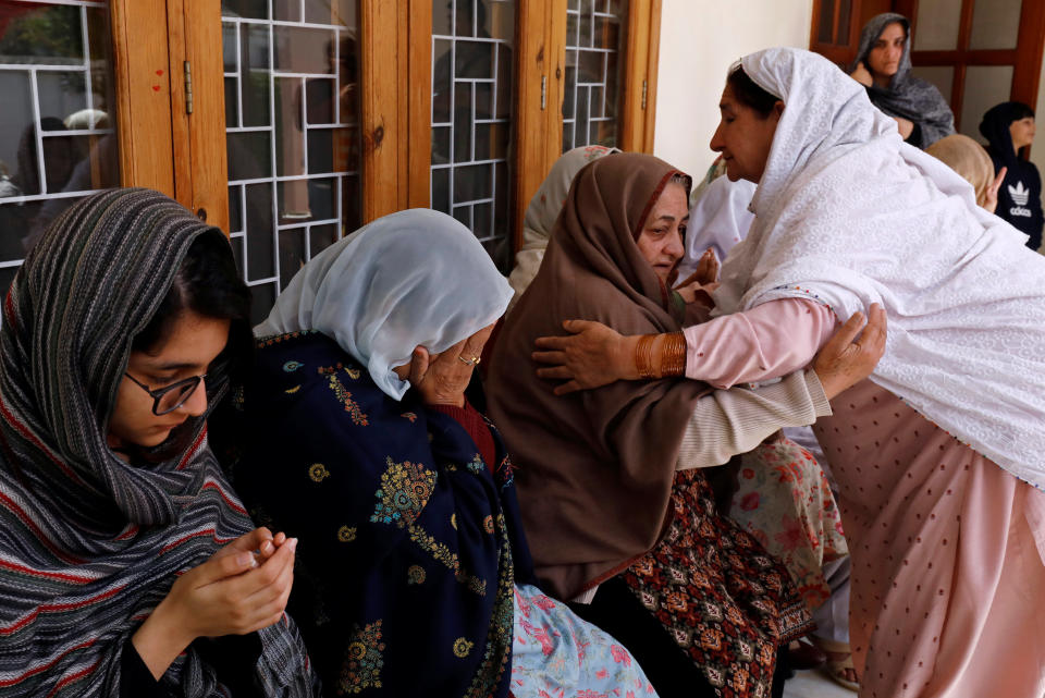 Relatives and family members of Naeem Rashid who was killed along with his son Talha Naeem in the Christchurch mosque attack in New Zealand, comfort each other during a condolence gathering at the family’s home in Abbottabad, Pakistan. Source: Reuters