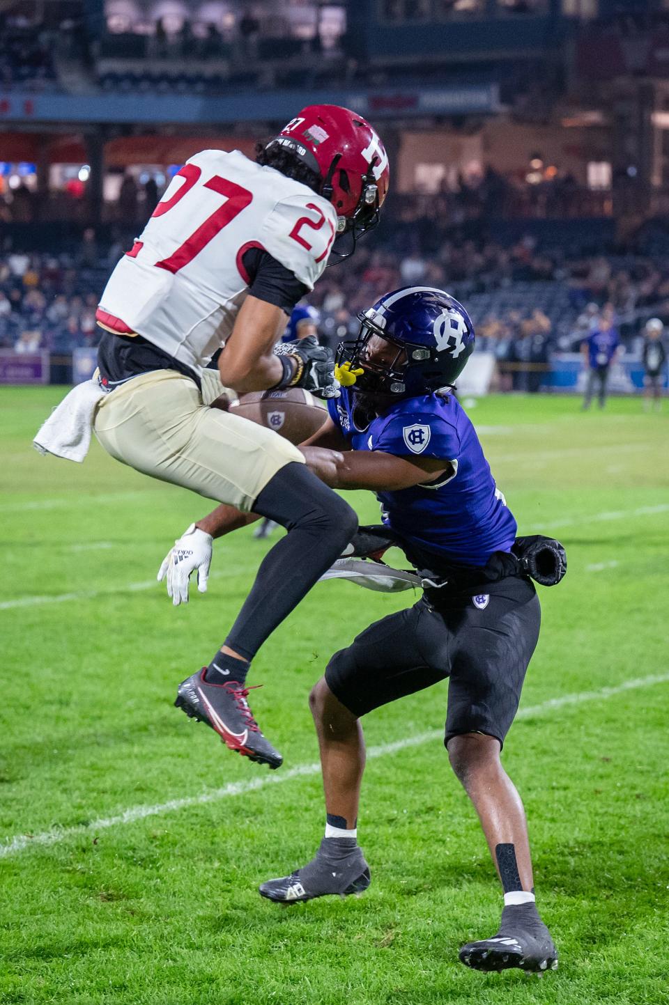 Harvard's A.J. Lopez breaks up a pass intended for Holy Cross’s Justin Shorter during the EBW Football Classic on Saturday September 30, 2023 at Polar Park in Worcester.