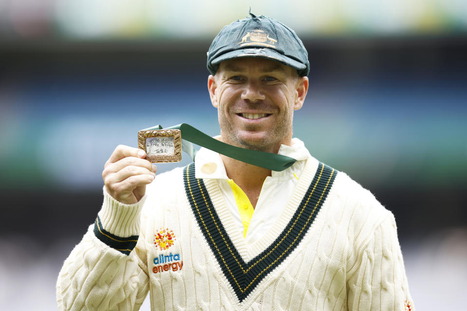 David Warner poses with his medal.