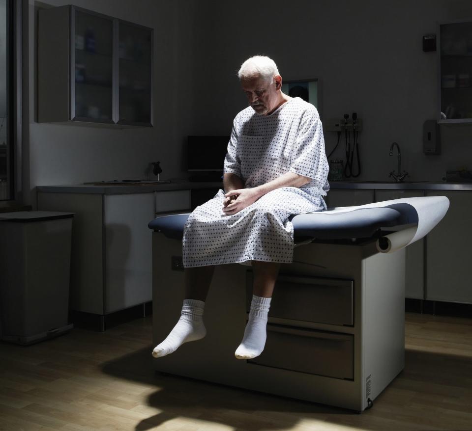 A man sitting on a bed in a doctor's office