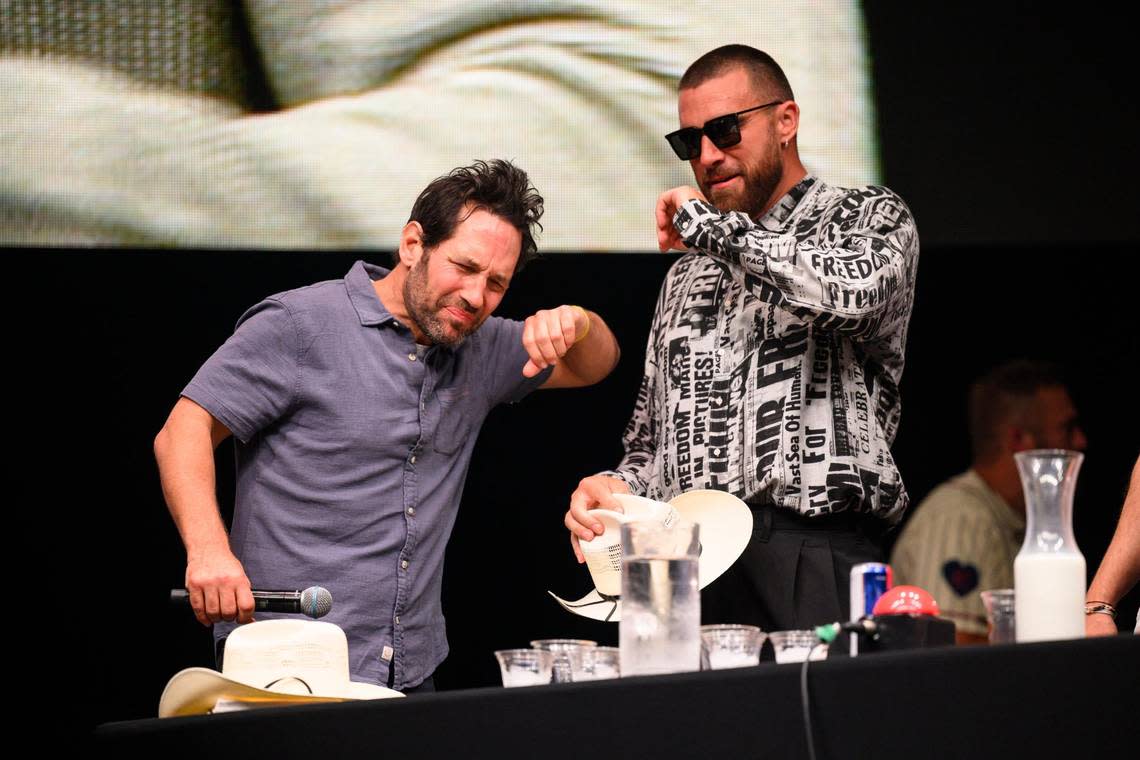 Big Slick host Paul Rudd, left, and Kansas City Chiefs tight end Travis Kelce can’t handle the heat of the spicy chicken wings they had to eat during a contest at the Big Slick party and show Saturday.