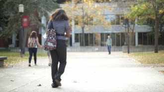 Person walking on college campus.