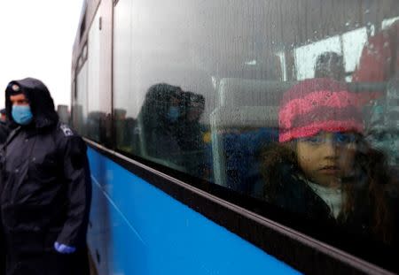 A migrant's child looks on as it sits inside a bus at a collection point in Roszke, Hungary, September 10, 2015. REUTERS/Laszlo Balogh