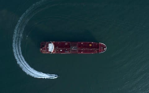 An aerial view shows a speedboat of Iran's Revolutionary Guard moving around the British-flagged oil tanker Stena Impero, which was seized in the Strait of Hormuz  - Credit: AP