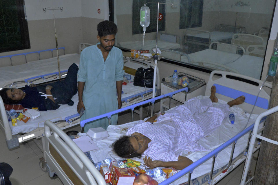 Injured victims of a passenger train derailed incident, are treated at a hospital, in Nawabshah, Pakistan, Sunday, Aug. 6, 2023. Railway officials say some passengers were killed and dozens more injured when a train derailed near the town of Nawabshah in southern Sindh province. (AP Photo/Pervez Masih)