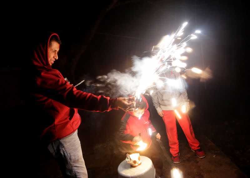 Jesus Mendoza and his sons play with fireworks during a posada at their farm in Jalpan se Serra