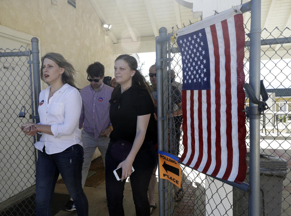 FILE - In this Tuesday, Nov. 6, 2018 file photo, Katie Hill, left, a Democratic candidate from California's 25th congressional district leaves a polling station after voting in Agua Dulce, Calif. Hill defeated Republican incumbent Steve Knight. (AP Photo/Marcio Jose Sanchez)