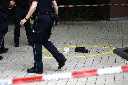 A police officer walks past crime scene after a knife attack in a supermarket in Hamburg, Germany, July 28, 2017. REUTERS/Morris Mac Matzen