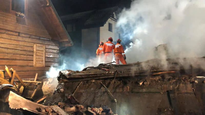 Firefighters work at the site of a building levelled by a gas explosion in Szczyrk