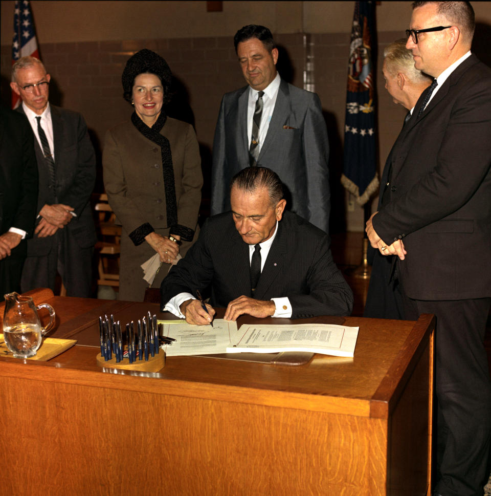 President Lyndon B Johnson signs the Higher Education Act in San Marcos, Texas, November 8, 1965. (Photo by Frank Wolfe/Interim Archives/Getty Images)