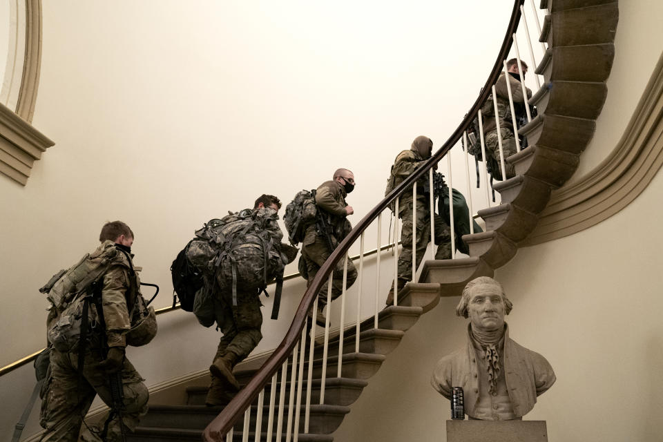 WASHINGTON, DC - JANUARY 13: Members of the National Guard wear protective masks while walking through the U.S. Capitol on January 13, 2021 in Washington, DC. Security has been increased throughout Washington following the breach of the U.S. Capitol last Wednesday, and leading up to the Presidential inauguration. (Photo by Stefani Reynolds/Getty Images)