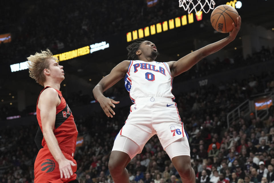 Philadelphia 76ers' Tyrese Maxey shoots next to Toronto Raptors' Gradey Dick during the second half of an NBA basketball game Saturday, Oct. 28, 2023, in Toronto. (Chris Young/The Canadian Press via AP)