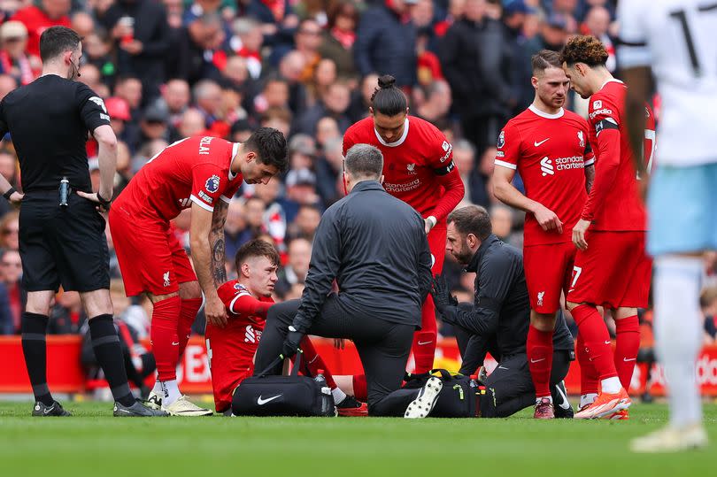 Conor Bradley of Liverpool goes down with an injury