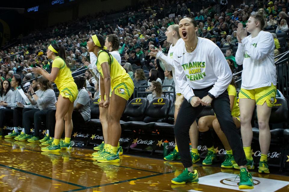 The Oregon bench celebrate a shot as the Oregon Ducks host the No. 16 Utah Utes Jan. 26 at Matthew Knight Arena in Eugene.