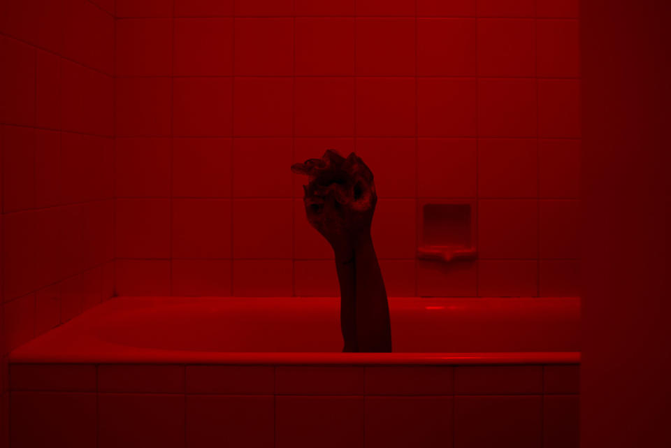 Scary hand sticking out of a bathtub