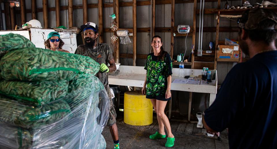 Anna Erickson, who co-leads Erickson & Jensen Shrimp Packers, gives instructions on what needs to be done while unloading a shrimp boat on Dec. 7, 2022. More than two months after Hurricane Ian decimated the shrimp fleet, glimmers of hope can be seen as the industry tries to rebuild.