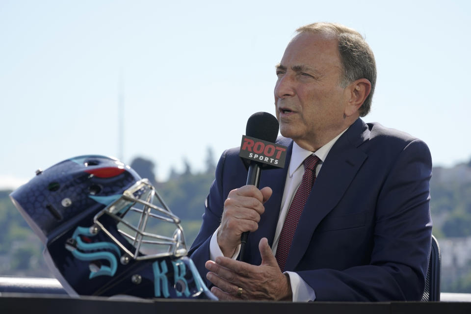 NHL Commissioner Gary Bettman takes part in an interview next to a Seattle Kraken NHL hockey goalie helmet Wednesday, July 21, 2021, during the Kraken's expansion draft event in Seattle. (AP Photo/Ted S. Warren)