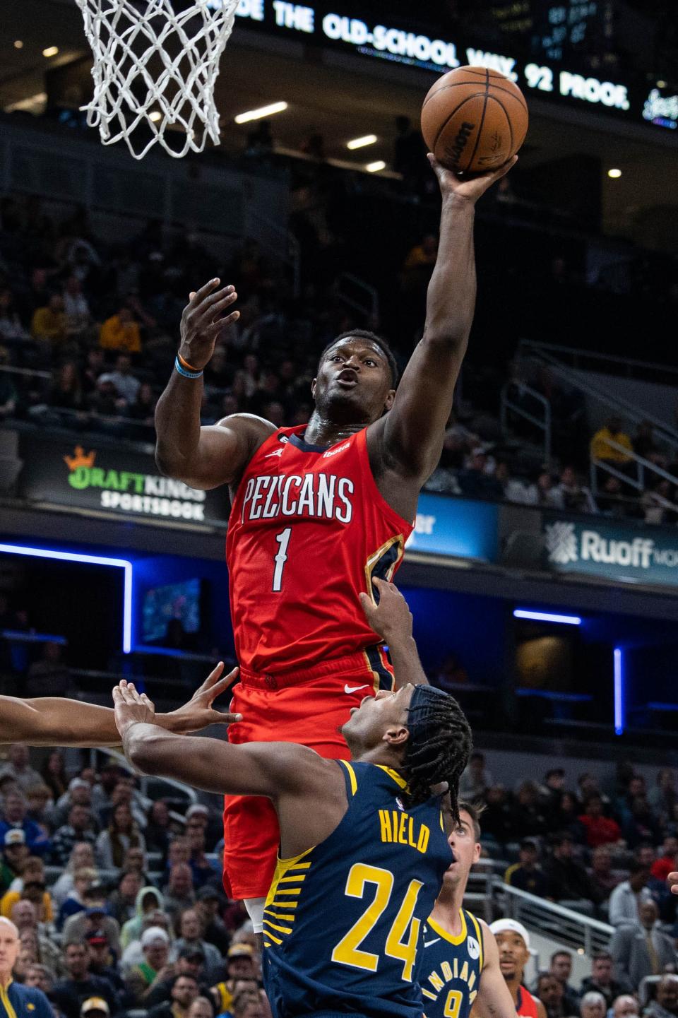 Zion Williamson takes it to the hoop over Buddy Hield.