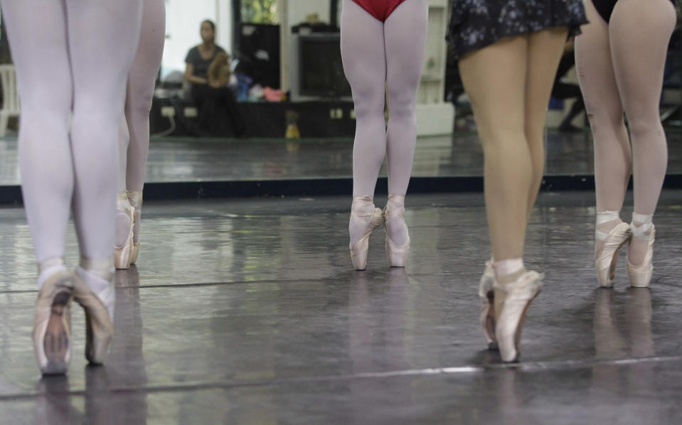 In this photo taken Nov. 25, 2012, Filipino slum dweller Jessa Balote, 3rd from right, points her toes with other students during a class at Ballet Manila at the Philippine capital. Balote, who used to tag along with her family as they collect garbage at a nearby dumpsite, is a scholar at Ballet Manila's dance program. As an apprentice, she makes around 7,000 pesos ($170) a month, sometimes double that, from stipend and performance fees. (AP Photo/Aaron Favila)