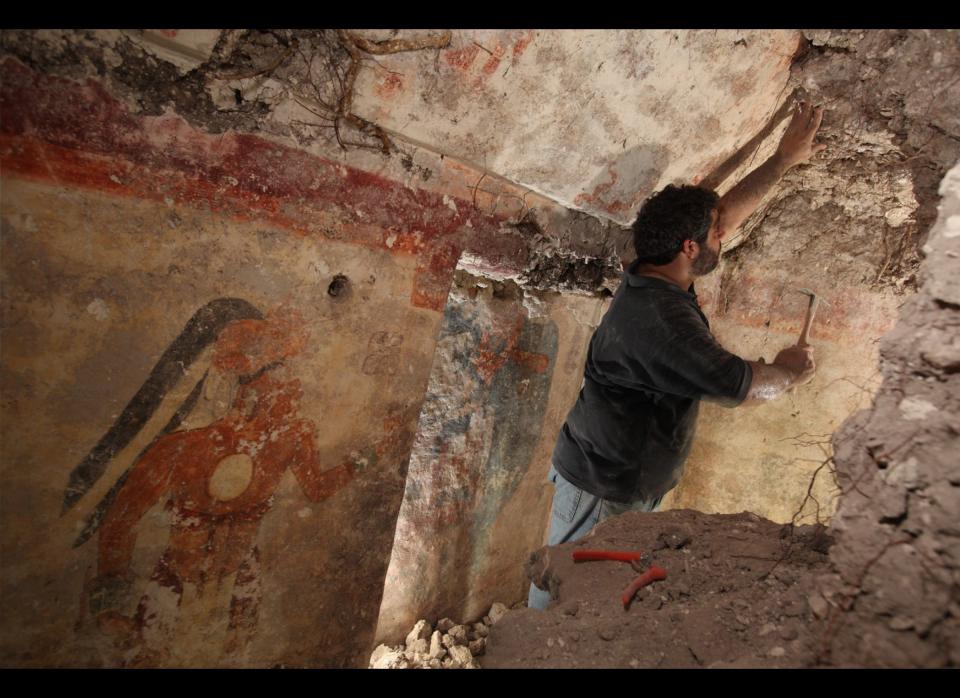 Archaeologist William Saturno of Boston University carefully uncovers art and writings left by the Maya some 1,200 years ago. The art and other symbols on the walls may have been records kept by a scribe, Saturno theorizes. Saturno's excavation and documentation of the house were supported by the National Geographic Society.     Photo by Tyrone Turner © 2012 National Geographic