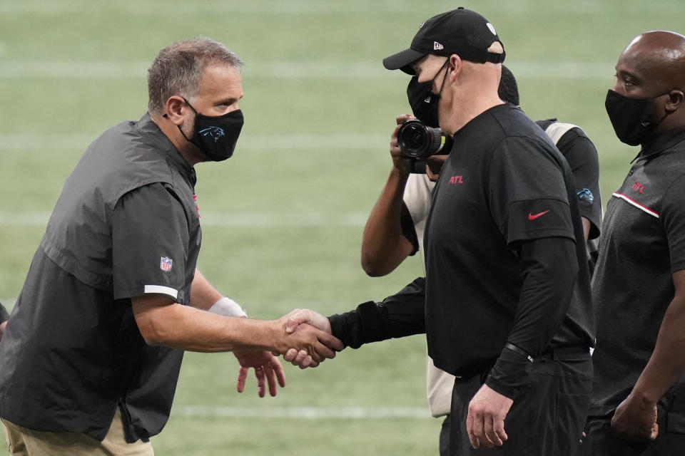 Carolina Panthers head coach Matt Rhule shakes hands with Atlanta Falcons head coach Dan Quinn after an NFL football game, Sunday, Oct. 11, 2020, in Atlanta. (AP Photo/Brynn Anderson)