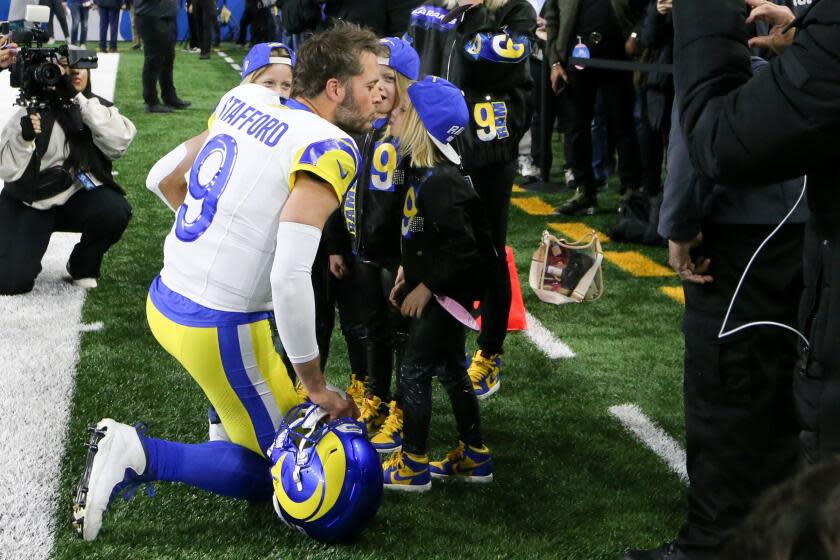 Rams quarterback Matthew Stafford (9) meets with his family before the NFC Wildcard game against the Detroit Lions