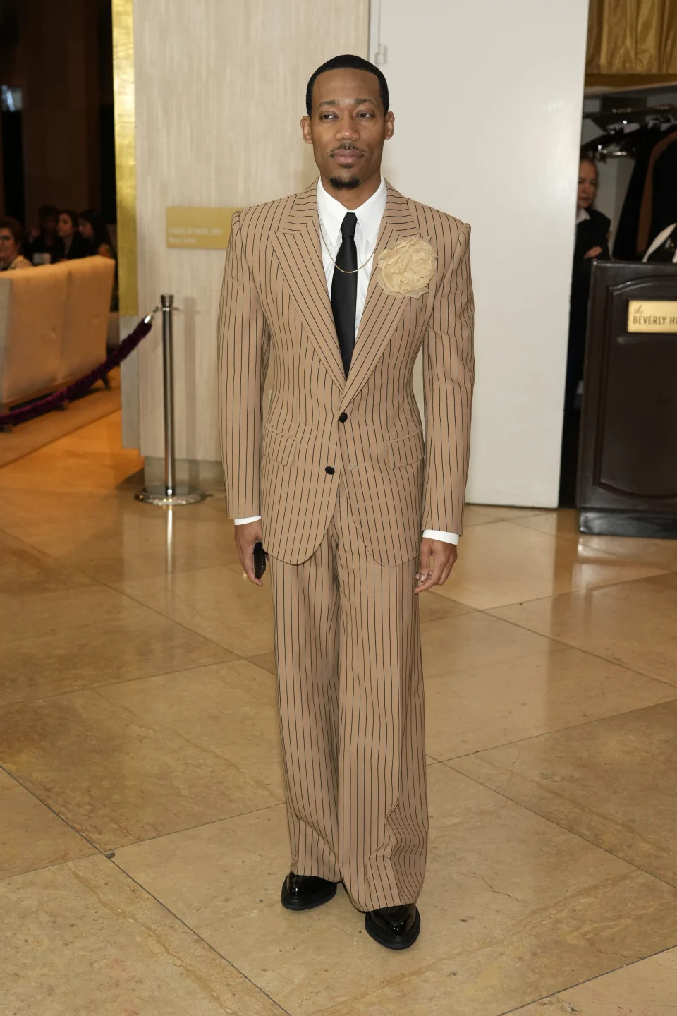 Tyler James Williams arrives at the 81st Golden Globe Awards on Sunday, Jan. 7, 2024, at the Beverly Hilton in Beverly Hills, Calif. (AP Photo/Chris Pizzello)