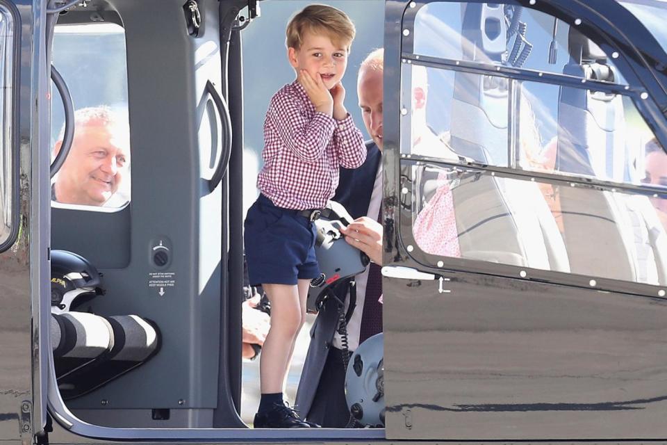 Young Prince George shows his excitement at being shown the inside of a helicopter (Getty)