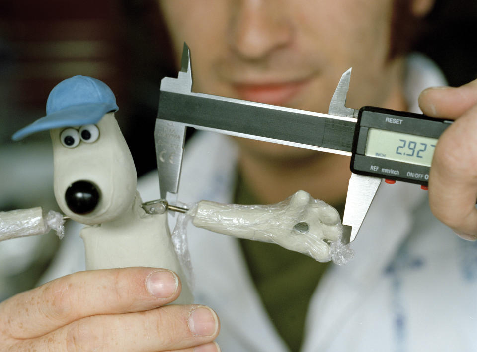 Jay Smart, Junior Model Maker, measuring Gromit. The average size of Wallace and Gromit is 8 inches although some are 6 or even 4 inches depending on the size of the film set. (Photo by In Pictures Ltd./Corbis via Getty Images)