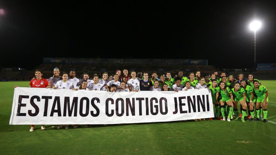 Hermoso's club CF Pachuca hold up a banner with a message that reads in Spanish; "We are with you Jenni." - Christian Chavez/AP