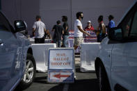 People wait in line at one of a few in person voting places during a nearly all-mail primary election Tuesday, June 9, 2020, in Las Vegas. (AP Photo/John Locher)