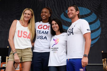 Jul 23, 2016; Los Angeles, CA, USA; American volleyball player Kerri Walsh-Jennings (left) and basketball player Tamika Catchings (second from left) and swimmer Janet Evans (second from right) and water polo player Tony Azevedo (right) pose for a photo during the Team USA Road to Rio tour announcement show at Venice Beach. Mandatory Credit: Kelvin Kuo-USA TODAY Sports