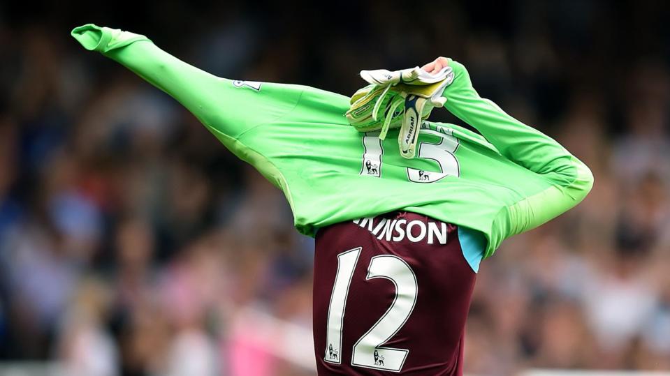 Carl Jenkinson puts on a goalkeeper top Credit: Alamy