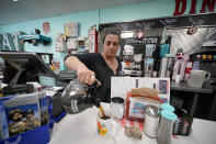 Tiffany Hollis, center, owner of the Dashing Diner, in Johnstown, Ohio, works the lunchtime rush, Thursday, June 9, 2022. From a business perspective, Intel is a great opportunity. “But when your heart is with a place—we don’t want it to happen,” Hollis said. “Like you want it to happen, but just not in your backyard.” (AP Photo/Gene J. Puskar)