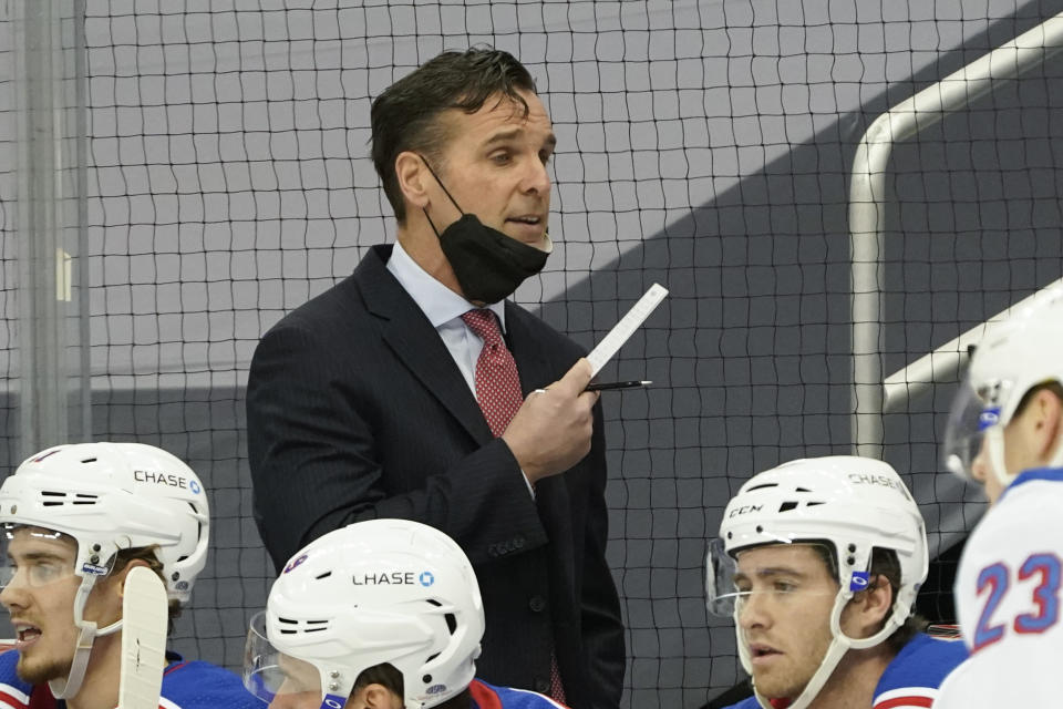 FILE - New York Rangers head coach David Quinn works from the bench as his team plays against the Pittsburgh Penguins during an NHL hockey game in Pittsburgh, in this Sunday, March 7, 2021, file photo. The New York Rangers fired coach David Quinn and three assistant coaches Wednesday, May 12, 2021, after missing the playoffs with one of the NHL's up-and-coming young teams. (AP Photo/Keith Srakocic), FIle