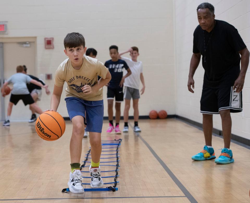 Reid Clark hones his basketball skills at a clinic for middle school students at the Wedgewood Community Center on Sept. 14. Clark is among the students from Santa Rosa County who travel to Escambia County to participate in youth sports.