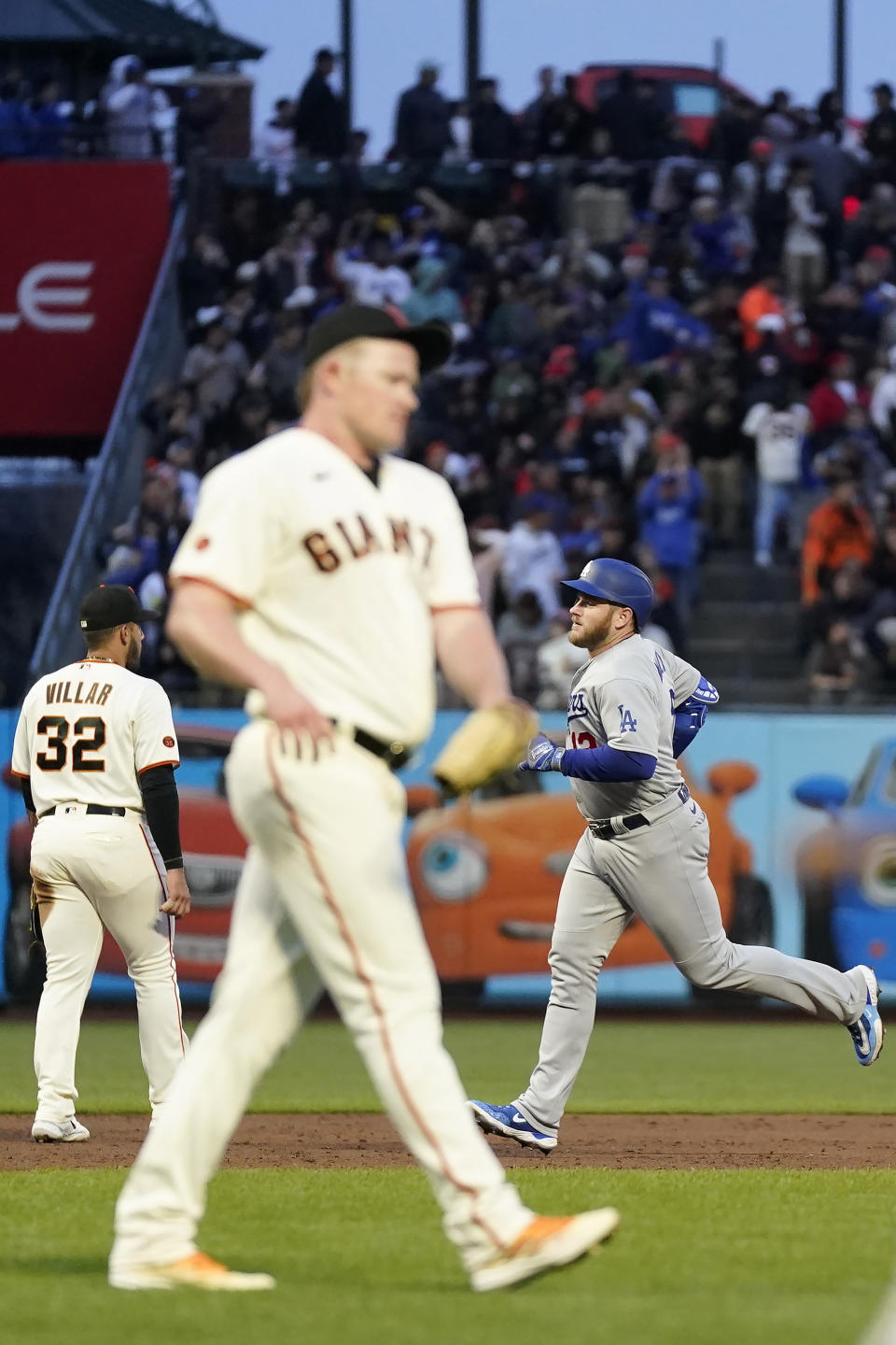 Los Angeles Dodgers' Max Muncy, right, rounds the bases after hitting a three-run home run off of San Francisco Giants pitcher Logan Webb, middle, during the third inning of a baseball game in San Francisco, Monday, April 10, 2023. (AP Photo/Jeff Chiu)