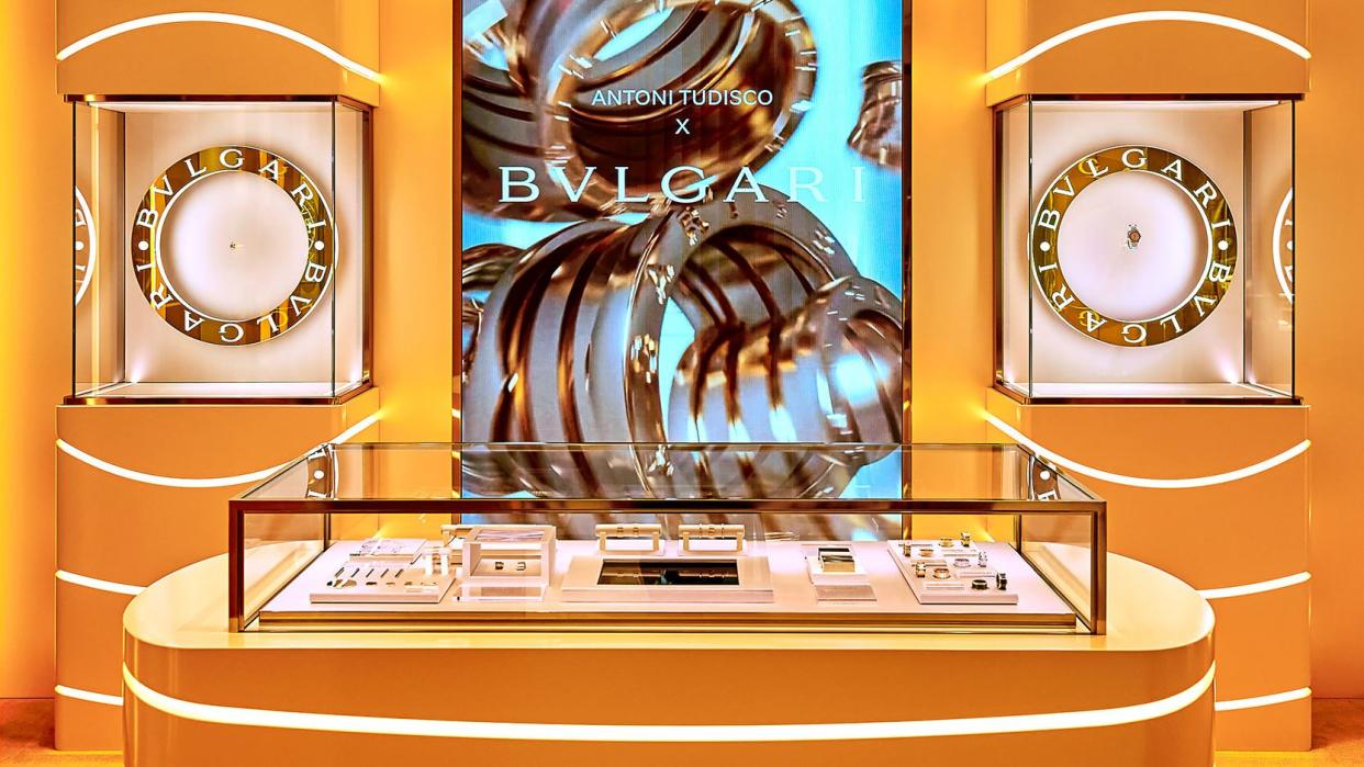 translucent orange cases with bright lights and cases with jewelry and the bulgari logo behind it