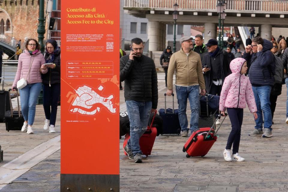 Tourists arrive in Venice, Italy, as it begins its pilot entry fee programme on Thursday, April 25, (AP)