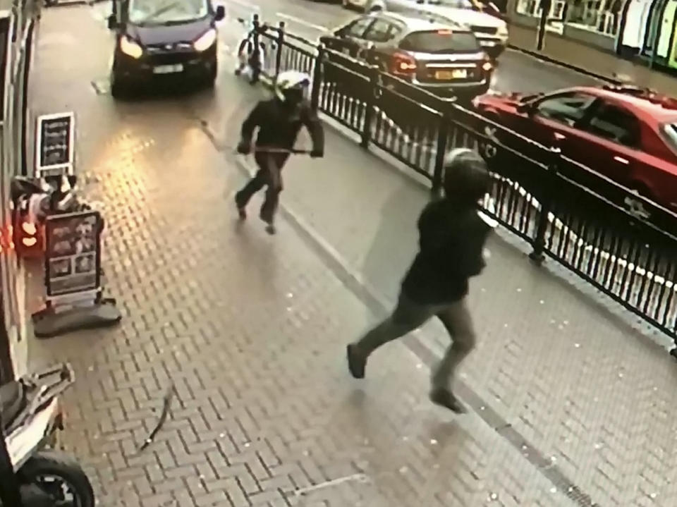 A van driver blocks the pavement to stop the gang from driving away. (SWNS)