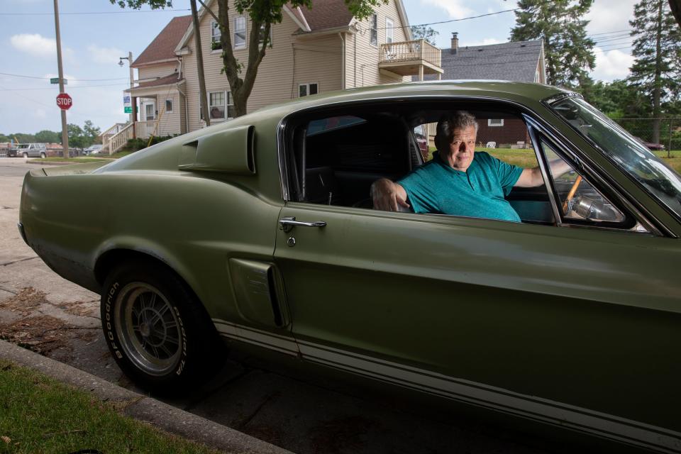 Romans, nws, hs, 3 of 6 - Mike Romans, owner of Roman's Pub, poses for a portrait in his 1967 Shelby GT350 on the street outside of his home and bar on Friday, July 19, 2019. Hannah Schroeder/ Milwaukee Journal Sentinel