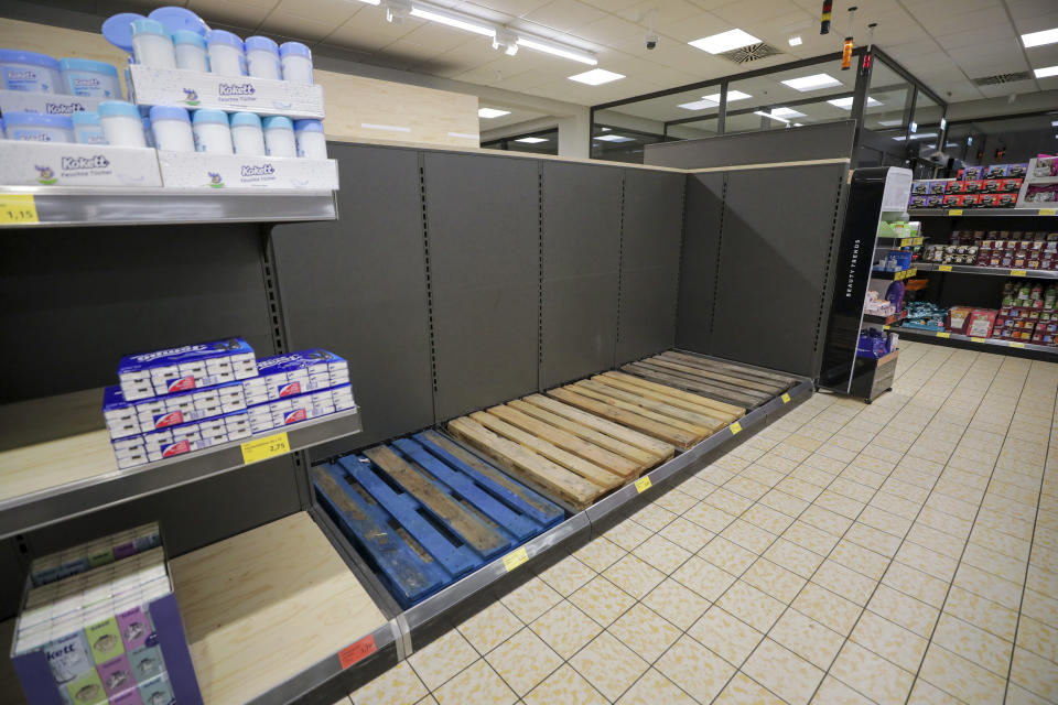 Photo shows empty pallets stand in the toilet paper aisle after selling out inside a Aldi Stores Ltd. supermarket in Hanau, Germany, on Monday, March 2, 2020.