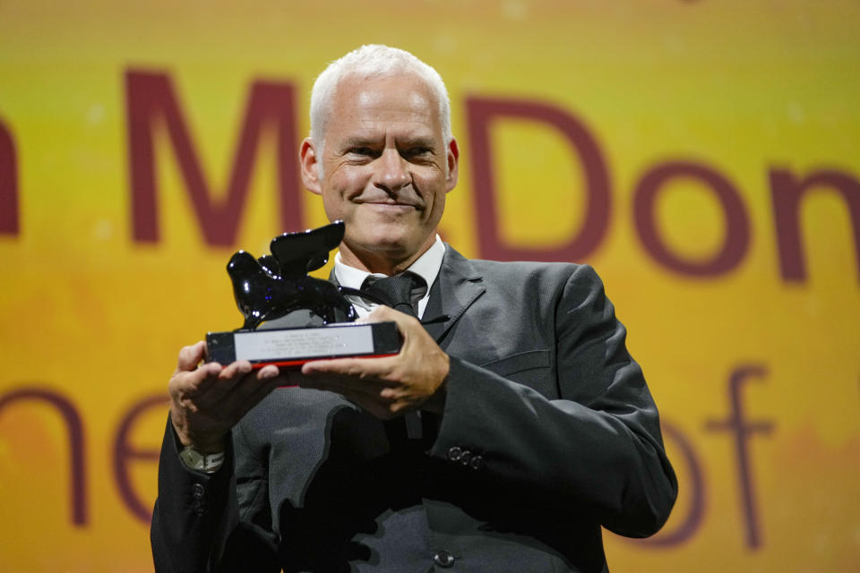 Director/writer Martin McDonagh holds the award for best screenplay for the film 'The Banshees of Inisherin' at the closing ceremony of the 79th edition of the Venice Film Festival in Venice, Italy, Saturday, Sept. 10, 2022. (AP Photo/Domenico Stinellis)
