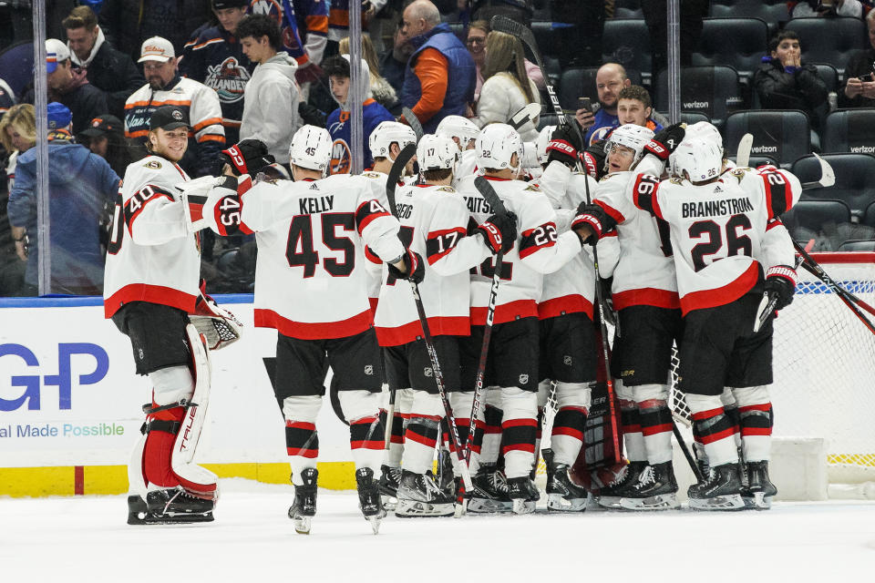 Ottawa Senators players celebrate defeating the New York Islanders after an NHL hockey game Tuesday, Feb. 14, 2023, in Elmont, N.Y. Senators won 3-2. (AP Photo/Eduardo Munoz Alvarez)