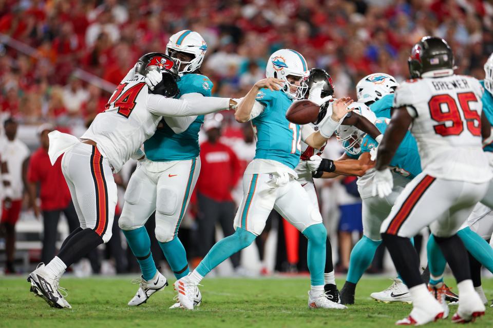 Aug 23, 2024; Tampa, Florida, USA; Tampa Bay Buccaneers defensive lineman Earnest Brown IV (74) pressures Miami Dolphins quarterback Mike White (14) in the second quarter during preseason at Raymond James Stadium. Mandatory Credit: Nathan Ray Seebeck-USA TODAY Sports